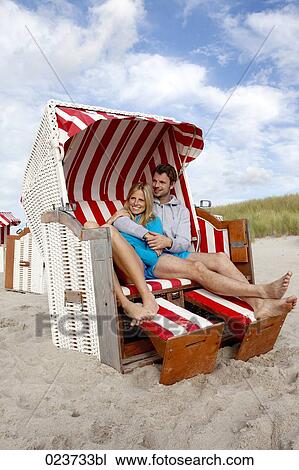 young couple relaxing in beach chair View Large Photo Image Stock Image - young couple relaxing in beach chair. Fotosearch