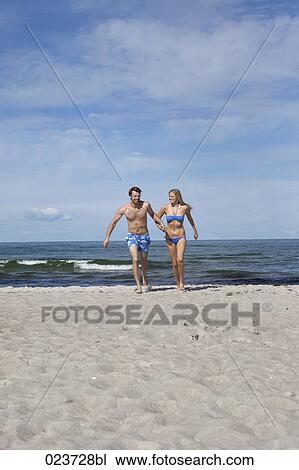 young couple running on beach View Large Photo Image Stock Image - young couple running on beach. Fotosearch