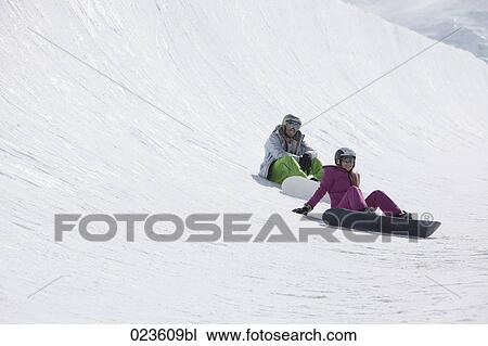 young couple snowboarding in the mountains View Large Photo Image Stock Image - young couple snowboarding in the mountains. Fotosearch