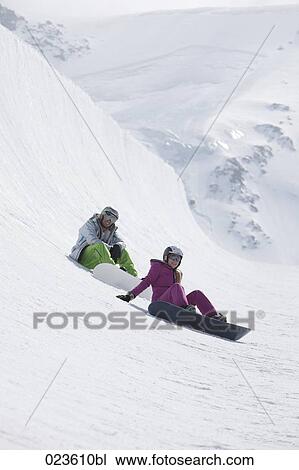 young couple snowboarding in the mountains View Large Photo Image Stock Image - young couple snowboarding in the mountains. Fotosearch