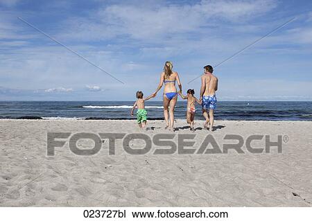 young family on beach running towards the sea View Large Photo Image Stock Image - young family on beach running towards the sea. Fotosearch