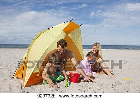 young family playing in front of tent on beach View Large Photo Image Stock Image - young family playing in front of tent on beach. Fotosearch