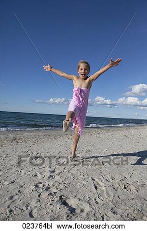 young girl having fun on beach View Large Photo Image Stock Image - young girl having fun on beach. Fotosearch