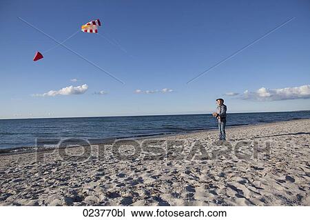 young girl playing with kite on beach View Large Photo Image Stock Image - young girl playing with kite on beach. Fotosearch