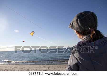 young girl playing with kite on beach View Large Photo Image Stock Image - young girl playing with kite on beach. Fotosearch