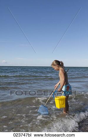 Stock Image - young girl wishing with spoon net. Fotosearch