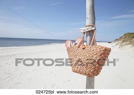 basket with flip flops hanging on pole at beach View Large Photo Image Stock Image - basket with flip flops hanging on pole at beach. Fotosearch