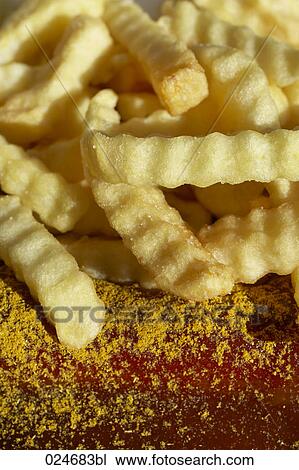Stock Image - close-up of chips with ketchup. Fotosearch