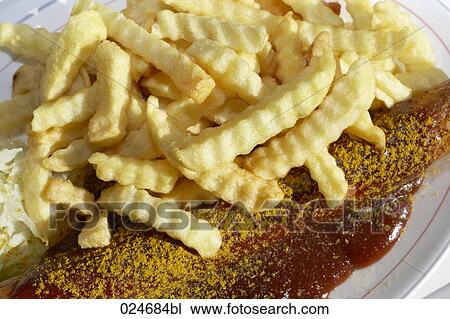 Stock Image - close-up of chips with ketchup. Fotosearch