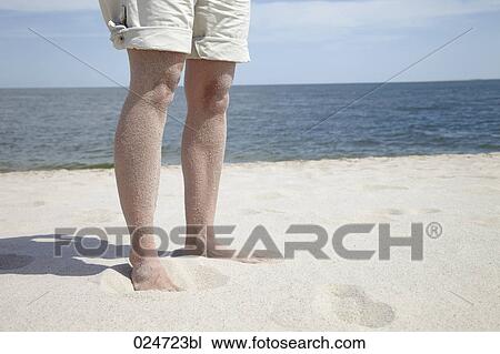 detail of woman standing on sandy beach View Large Photo Image Stock Image - detail of woman standing on sandy beach. Fotosearch