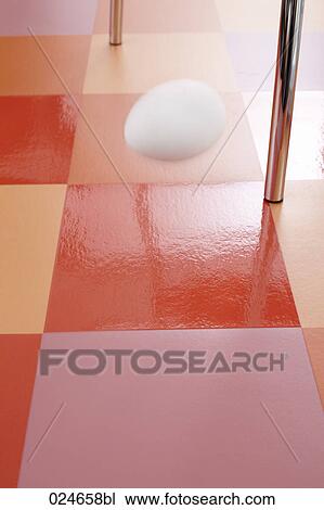 Stock Image - egg falling on floor. Fotosearch
