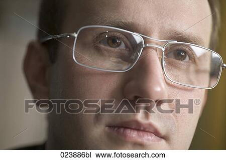 Stock Image - headshot of businessman wearing glasses. Fotosearch