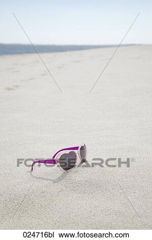 heart shaped sunglasses on sandy beach View Large Photo Image Stock Image - heart shaped sunglasses on sandy beach. Fotosearch