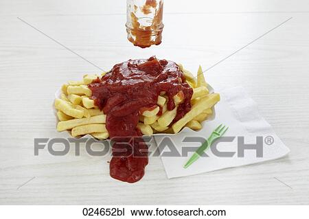 Stock Image - ketchup spilled over portion of chips. Fotosearch