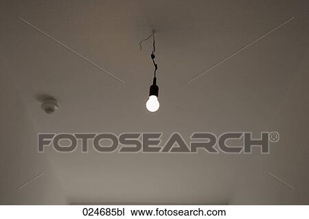 Stock Photo Of Light Bulb Hanging From Ceiling In Empty Flat Light Bulb Hanging From Ceiling In Empty Flat