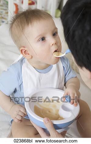 mother feeding baby boy View Large Photo Image Stock Image - mother feeding baby boy. Fotosearch