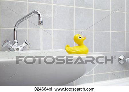 overflowing sink in bathroom with yellow rubber duck View Large Photo Image Stock Image - overflowing sink in bathroom with yellow rubber duck. Fotosearch