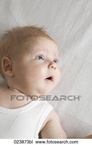 Stock Image - portrait of astonished baby boy. Fotosearch