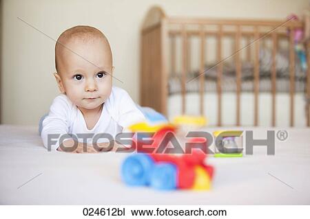 Stock Image - portrait of baby boy with toys. Fotosearch