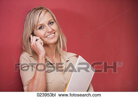 Stock Image - portrait of businesswoman talking on mobile phone. Fotosearch