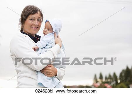 portrait of mother holding baby boy View Large Photo Image Stock Image - portrait of mother holding baby boy. Fotosearch