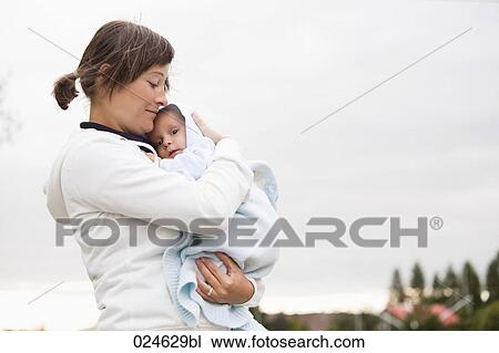 portrait of mother holding baby boy View Large Photo Image Stock Image - portrait of mother holding baby boy. Fotosearch