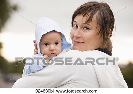 Stock Image - portrait of mother holding baby boy. Fotosearch