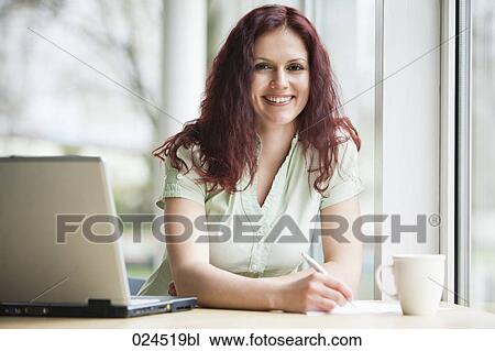 portrait of red haired businesswoman working with laptop computer View Large Photo Image Stock Image - portrait of red haired businesswoman working with laptop computer. Fotosearch