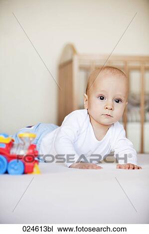 Stock Image - portrait of young baby boy with toy. Fotosearch