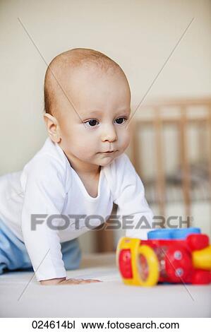 Stock Image - portrait of young baby boy with toy. Fotosearch