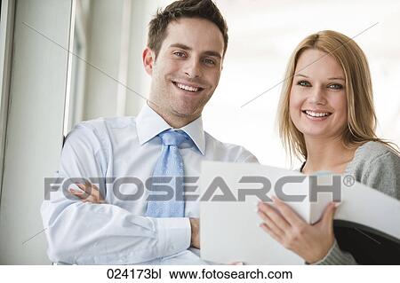 Stock Image - portrait of young businessman and female assistant. Fotosearch