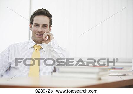 portrait of young businessman at desk View Large Photo Image Stock Image - portrait of young businessman at desk. Fotosearch