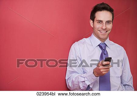 portrait of young businessman checking his mobile phone View Large Photo Image Stock Image - portrait of young businessman checking his mobile phone. Fotosearch