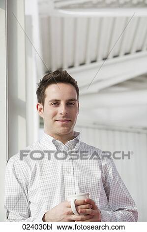 portrait of young businessman holding cup View Large Photo Image Stock Image - portrait of young businessman holding cup. Fotosearch