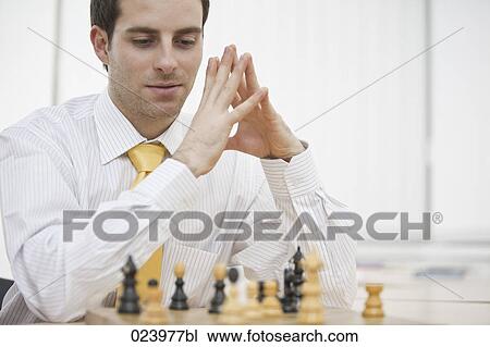 portrait of young businessman playing chess View Large Photo Image Stock Image - portrait of young businessman playing chess. Fotosearch