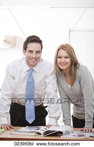 Stock Image - portrait of young businessman with female colleague. Fotosearch