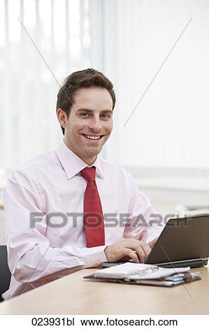 portrait of young businessman working with laptop computer View Large Photo Image Stock Image - portrait of young businessman working with laptop computer. Fotosearch