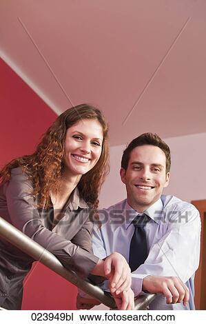 Stock Image - portrait of young businesswoman and male colleague. Fotosearch