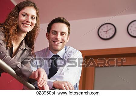 Stock Image - portrait of young businesswoman and male colleague. Fotosearch