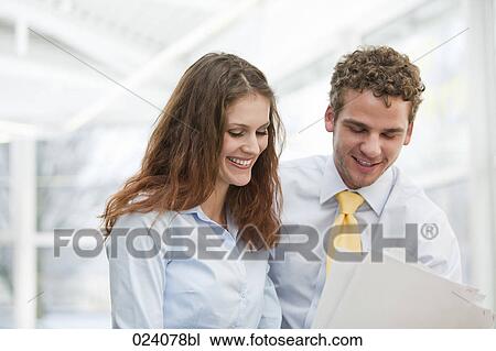 Stock Image - portrait of young businesswoman and male colleague. Fotosearch