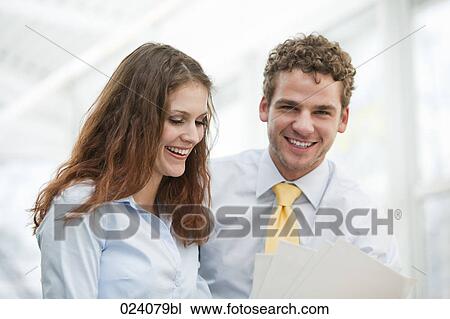 Stock Image - portrait of young businesswoman and male colleague. Fotosearch