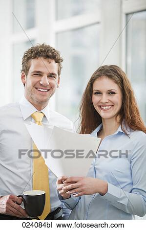 Stock Image - portrait of young businesswoman and male colleague. Fotosearch
