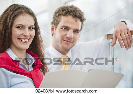 Stock Image - portrait of young businesswoman and male colleague. Fotosearch