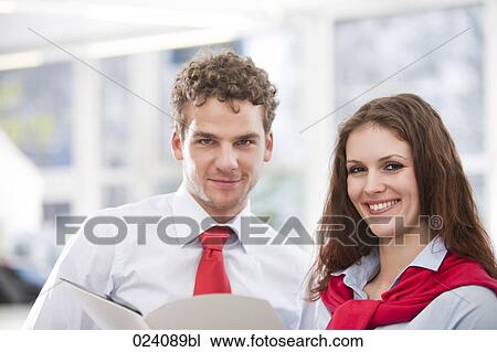 Stock Image - portrait of young businesswoman and male colleague. Fotosearch