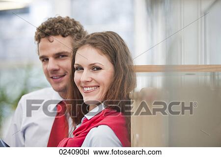 Stock Image - portrait of young businesswoman and male colleague. Fotosearch