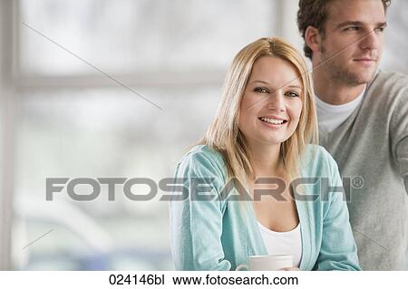 Stock Image - portrait of young businesswoman and male colleague. Fotosearch
