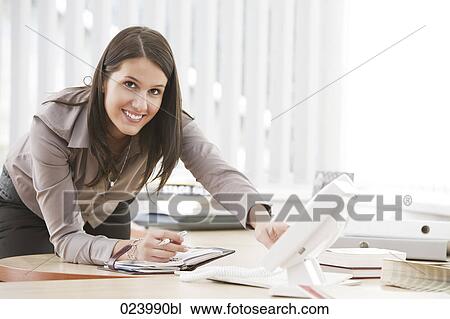 portrait of young businesswoman at desk View Large Photo Image Stock Image - portrait of young businesswoman at desk. Fotosearch