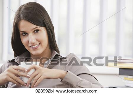 portrait of young businesswoman having cup of coffee View Large Photo Image Stock Image - portrait of young businesswoman having cup of coffee. Fotosearch