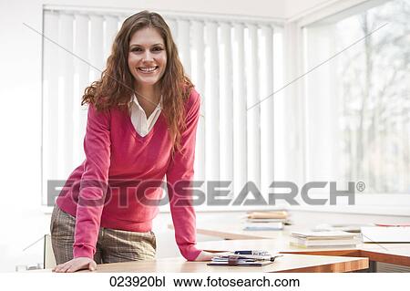Stock Image - portrait of young businesswoman in office. Fotosearch