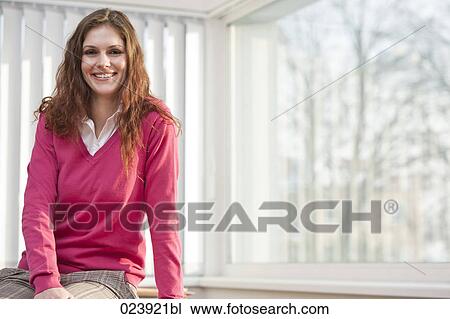 Stock Image - portrait of young businesswoman in office. Fotosearch